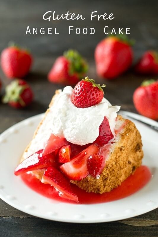 Gluten Free Angel Food Cake topped with strawberries and whipped cream