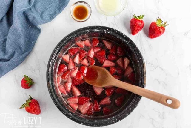 making strawberry sauce in a saucepan