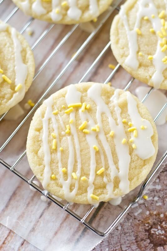 Lemon Sugar Cookies by Tastes of Lizzy T. Light, tangy, crisp on the outside, chewy on the inside, soft sugar cookies with a lemon glaze drizzle. Better than a bakery!