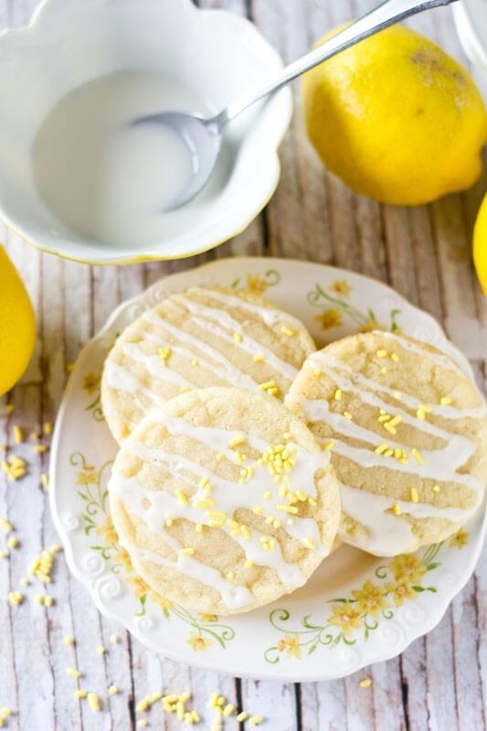 Lemon Sugar Cookies by Tastes of Lizzy T. Light, tangy, crisp on the outside, chewy on the inside, soft sugar cookies with a lemon glaze drizzle. Better than a bakery!