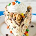 Your favorite cookie meets creamy cheesecake! This Monster Cookie Cheesecake will be a hit with cookie and cheesecake lovers alike. Cookie crust with M&M's swired throughout and a chocolate ganache topping.