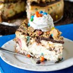 Your favorite cookie meets creamy cheesecake! This Monster Cookie Cheesecake will be a hit with cookie and cheesecake lovers alike. Cookie crust with M&M's swired throughout and a chocolate ganache topping.