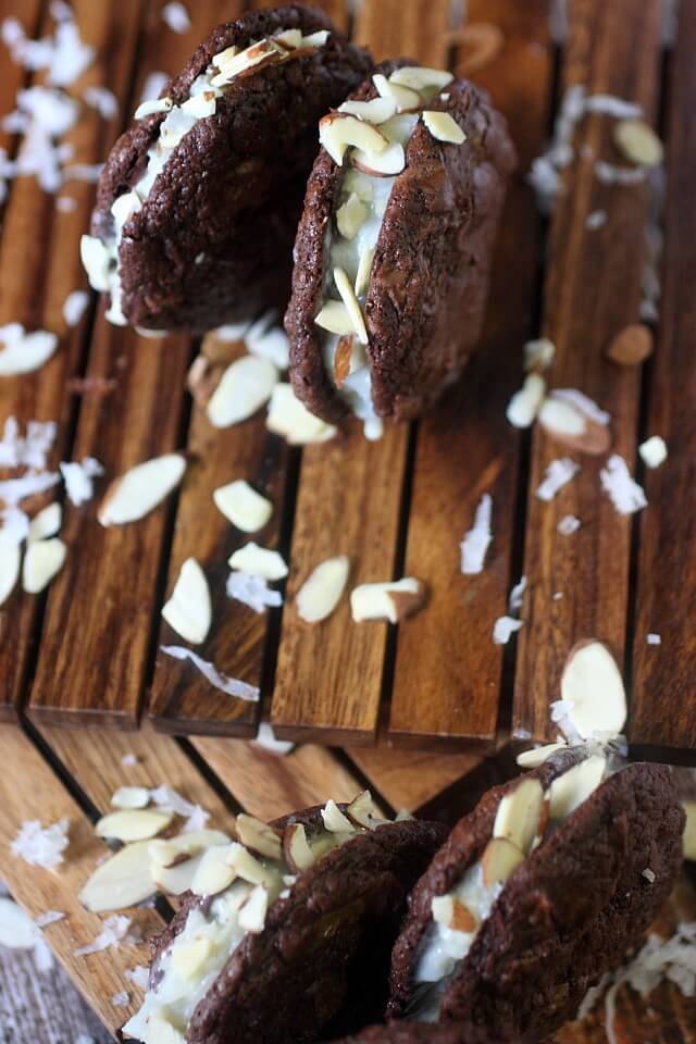 A Sweet coconut and almond filling is sandwiched between two soft baked brownie cookies. If there is ever a cookie you need to try – These Almond Joy Brownie Sandwich Cookies are the one!