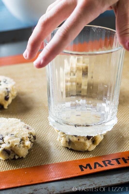 pressing cookie dough with a sugared glass