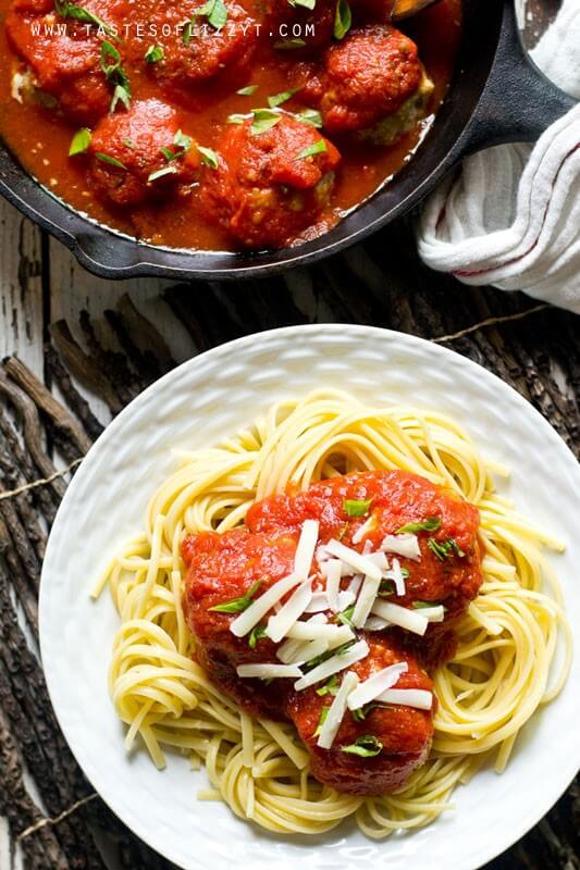 overhead photo looking down on a plate of pasta with meatballs in red gravy