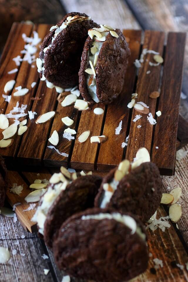 A Sweet coconut and almond filling is sandwiched between two soft baked brownie cookies. If there is ever a cookie you need to try – These Almond Joy Brownie Sandwich Cookies are the one!