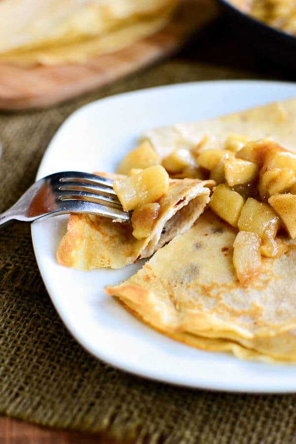 plate of whole wheat apple cider crepes stuffed with vanilla yogurt and topped with apple pie filling