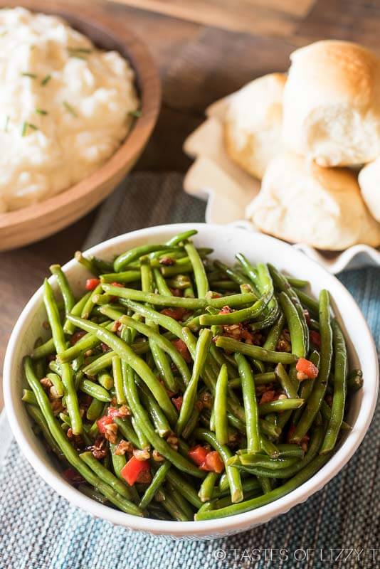 Christmas green beans are dressed up with pimentos and chopped pecans that are caramelized in butter and honey. A simple, healthy side dish to complete your family dinner.