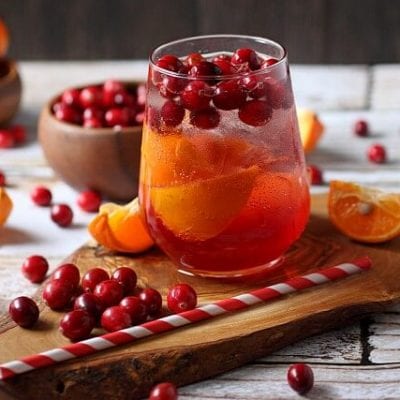 Tart cranberries, juicy tangerines, and tickly bubbles make this Cranberry Tangerine Fizzy drink recipe the BEST holiday drink! Homemade Soda for Christmas parties.