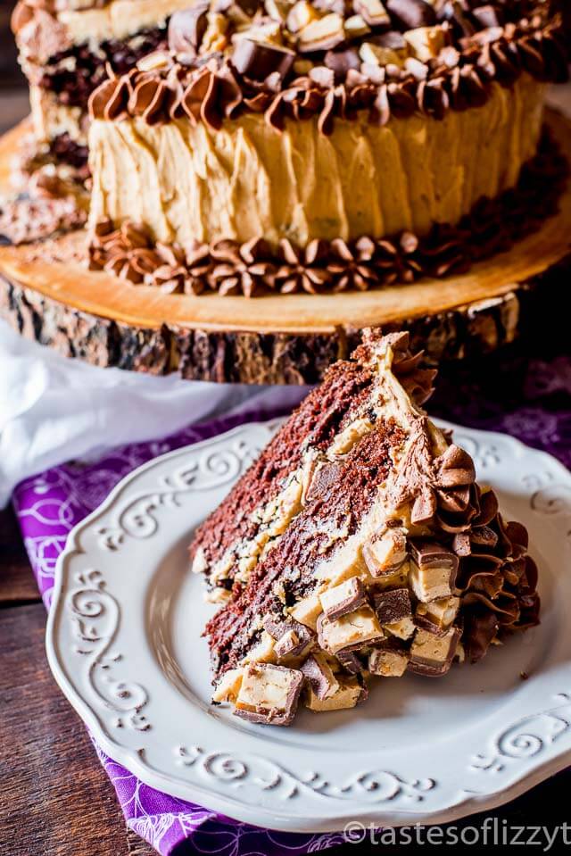 Chocolate cake layered with peanut butter frosting and chopped peanut butter Snickers bars make this Snickers cake a must for all chocolate peanut butter lovers.