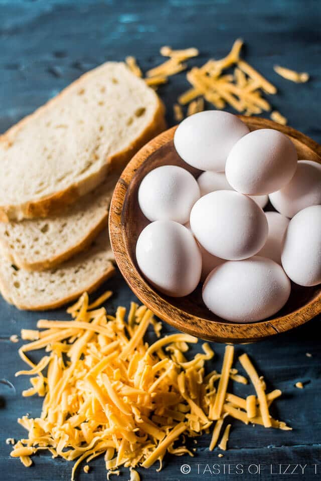 eggs, cheese and bread sitting on a table