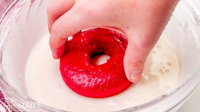 dipping donuts into glaze