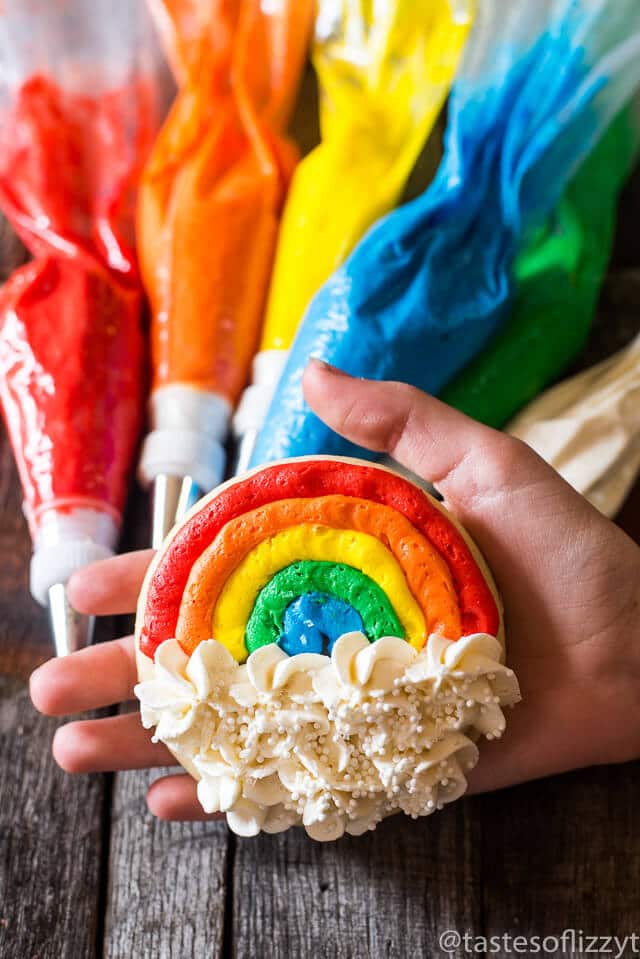 Soft, Lofthouse-style cutout sugar cookies in simple circle shapes make easy decorated rainbow cookies that anyone can do. Uses just two decorating tips!