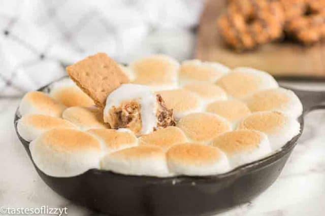 gooey s'mores dip with a graham cracker
