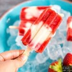 hand holding a strawberry popsicle