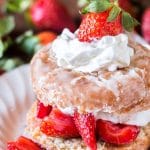 A close up of a strawberry shortcake donut