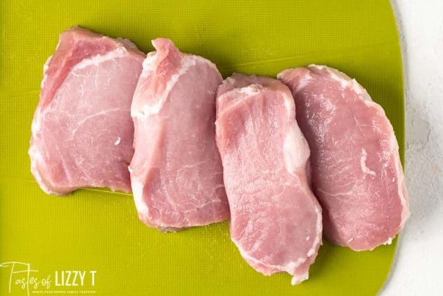 pork chops on cutting board
