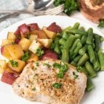 pork chop, potatoes and green beans on a plate