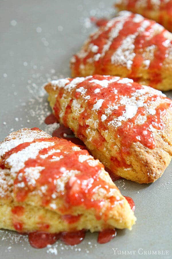 Fluffy and light, extra lemony scones drizzled with the most perfect fresh strawberry glaze. These Lemon Scones with Strawberry Glaze are a perfect pick-me-up.