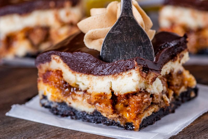 a piece of cheesecake on a table with a fork in it