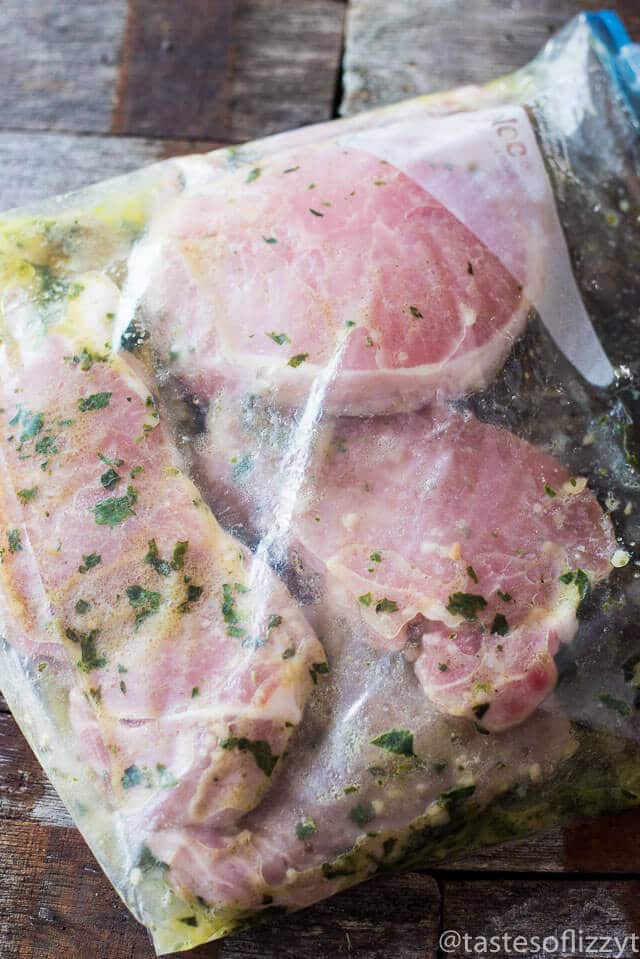 boneless pork chops in a zip top plastic bag with a 4 ingredient lemon basil marinade