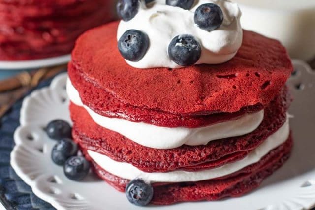 stack of red velvet pancakes with blueberries