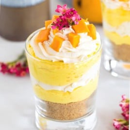 Creamy mango cheesecake, freshly whipped cream and topped with fresh mangoes, what's not to love? The perfect no bake summer dessert.