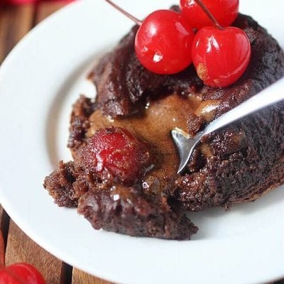 Who turns Chocolate Covered Cherries into Molten Chocolate Cake? This gal! Rich gooey chocolate cake encases a surprise center of maraschino cherries that is sure to delight!