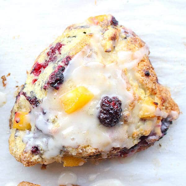 overhead shot of blackberry peach scones with glaze