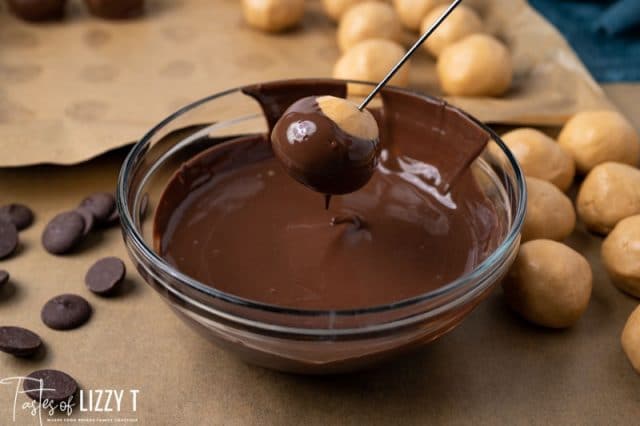 dipping peanut butter ball dipped in chocolate