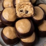 cookie dough buckeyes on a plate with one bite out
