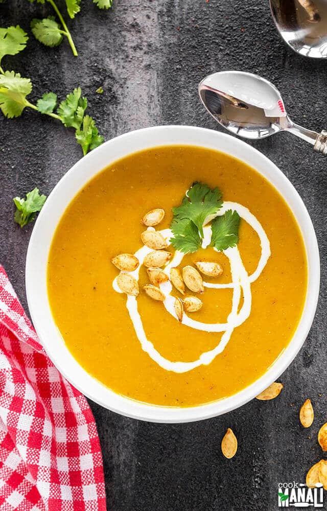 bowl of creamy vegan soup made with pumpkin, carrots and apples
