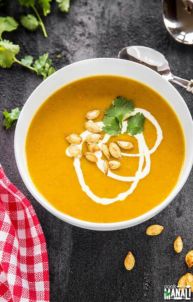 bowl of creamy pumpkin soup made with pumpkin, carrots and apples