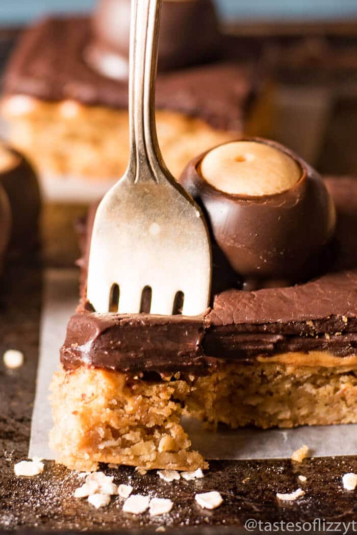 A close up of a piece of peanut butter bar with a fork in it