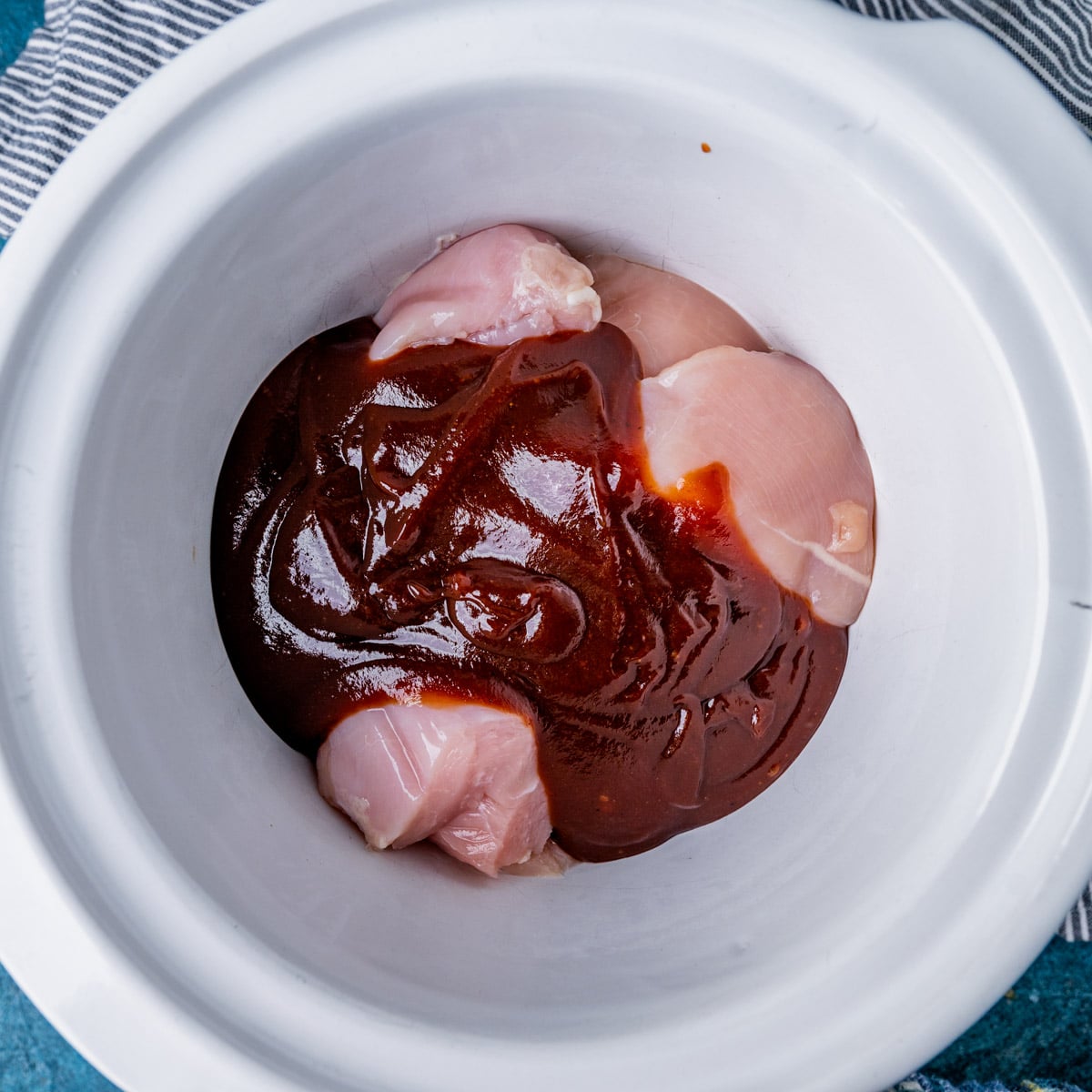 chicken and bbq sauce in a slow cooker