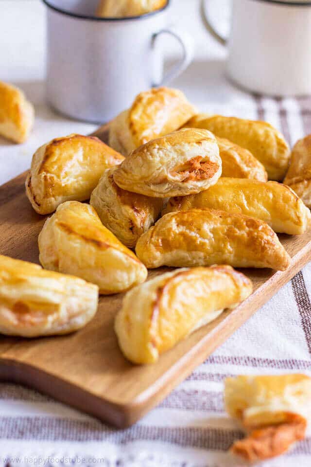 tuna empanadas on a wooden cutting board