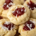 A close up of coconut thumbprint cookies