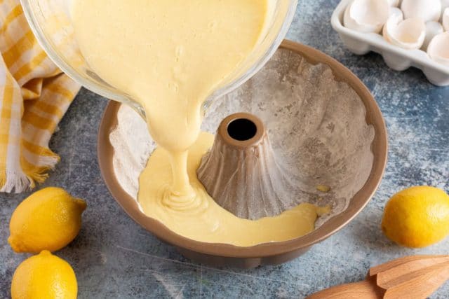 pouring cake batter into a bundt pan