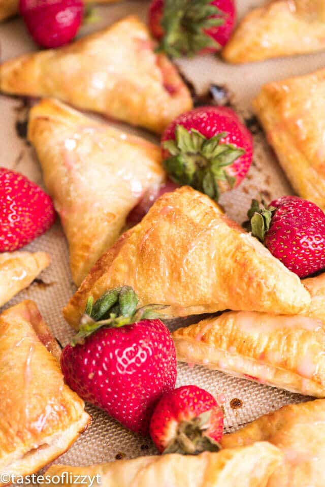 Quick and easy strawberry turnovers made with puff pastry and stuffed with fresh strawberry filling. Drizzle with glaze for a beautiful spring brunch recipe.
