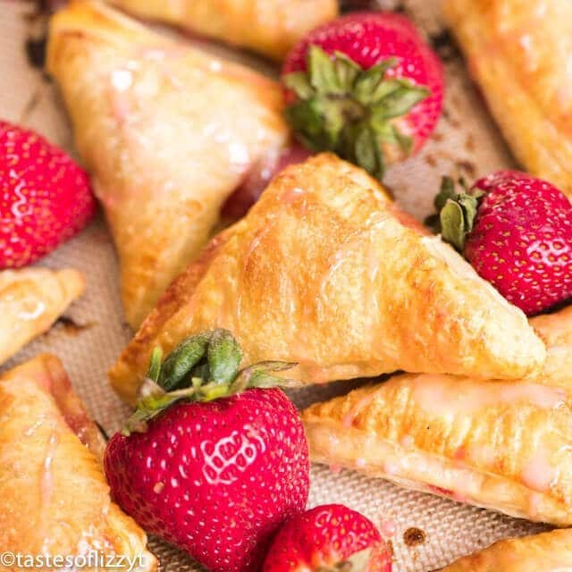Quick and easy strawberry turnovers made with puff pastry and stuffed with fresh strawberry filling. Drizzle with glaze for a beautiful spring brunch recipe.
