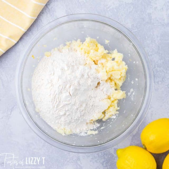 flour over butter/sugar mixture in a glass bowl