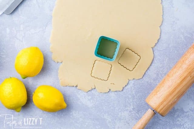 lemon shortbread dough rolled out with cookie cutter on it