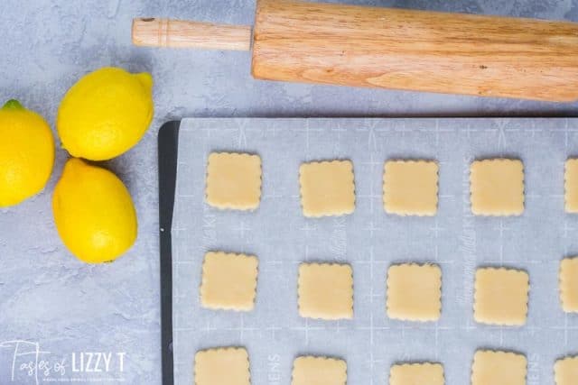 cookies cut out on a parchment paper baking sheet