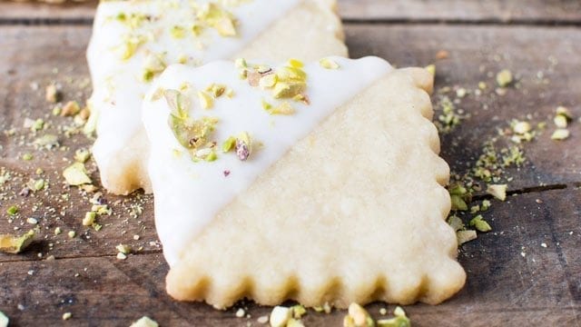 square cut lemon shortbread cookie dipped in white chocolate and pistachio