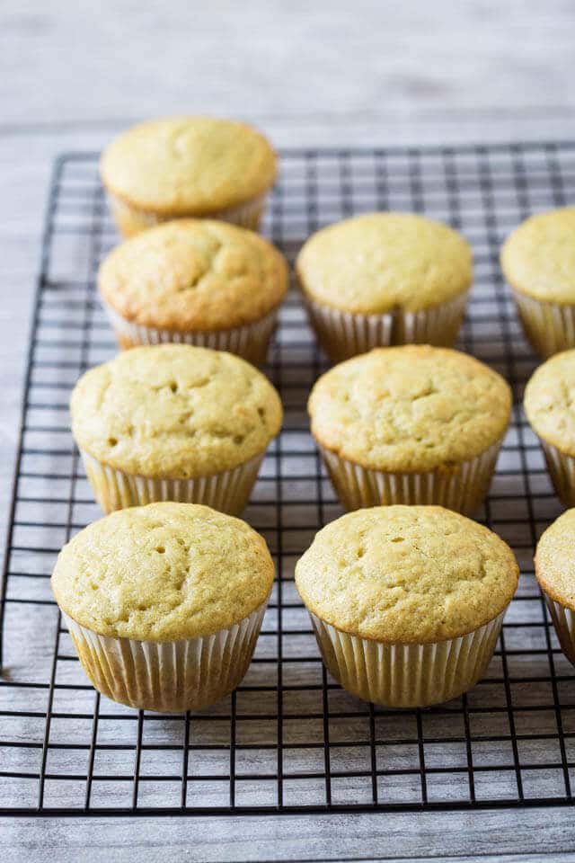 unfrosted pineapple cupcakes on a wire rack