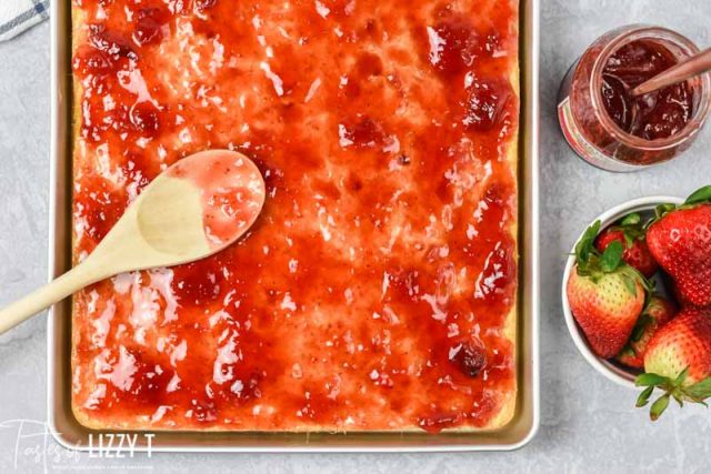 strawberry jam spread on a sheet cake
