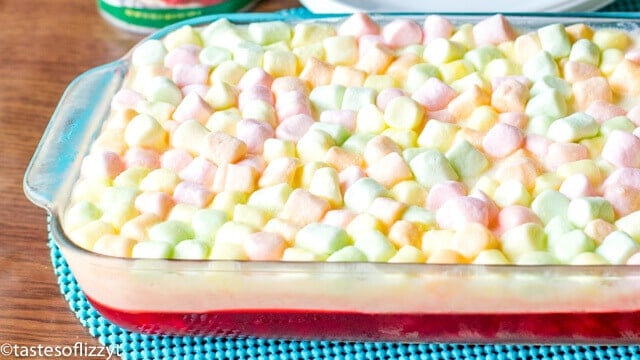 This Cherry Pineapple Marshmallow Jello Salad is a long-time family favorite recipe. There's a cherry layer paired with a tangy lemon cream cheese layer.