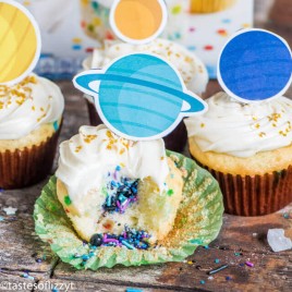 solar system cupcakes, one with a bite out