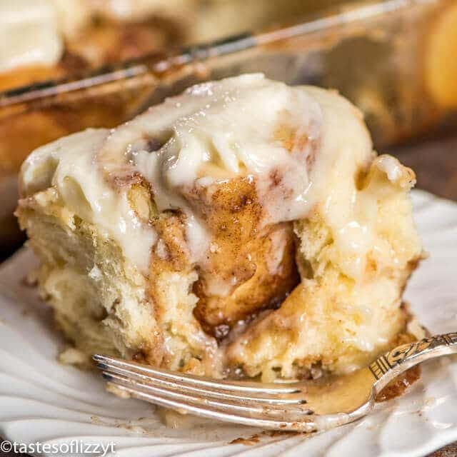 cinnamon roll on a plate with a bite out of it