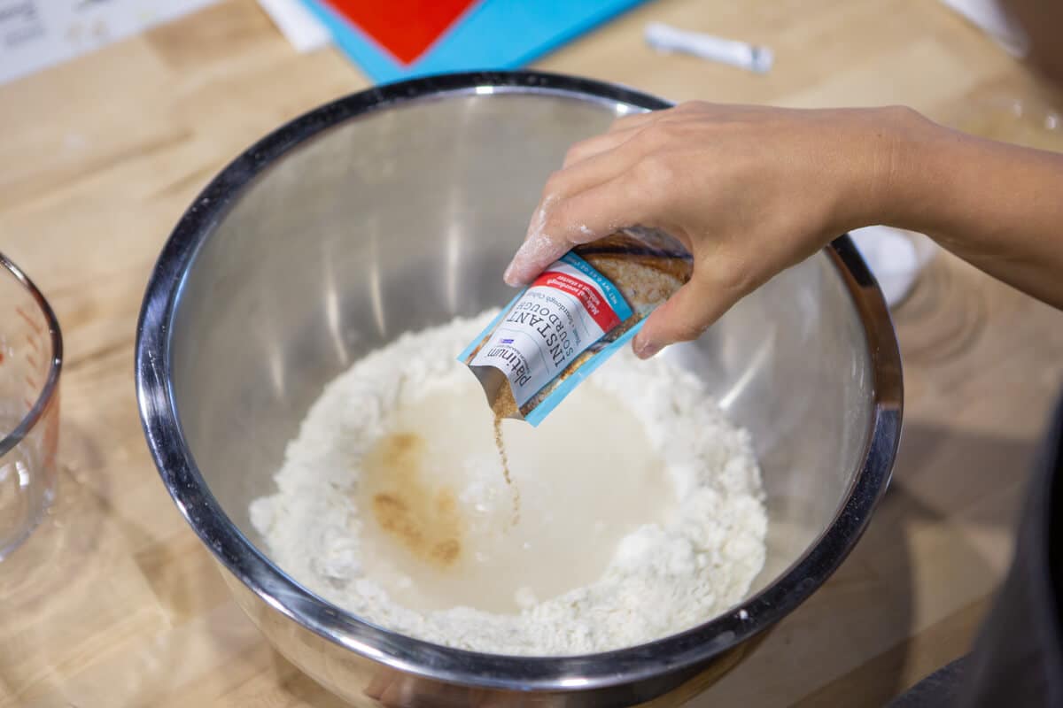 pouring yeast into mixing bowl